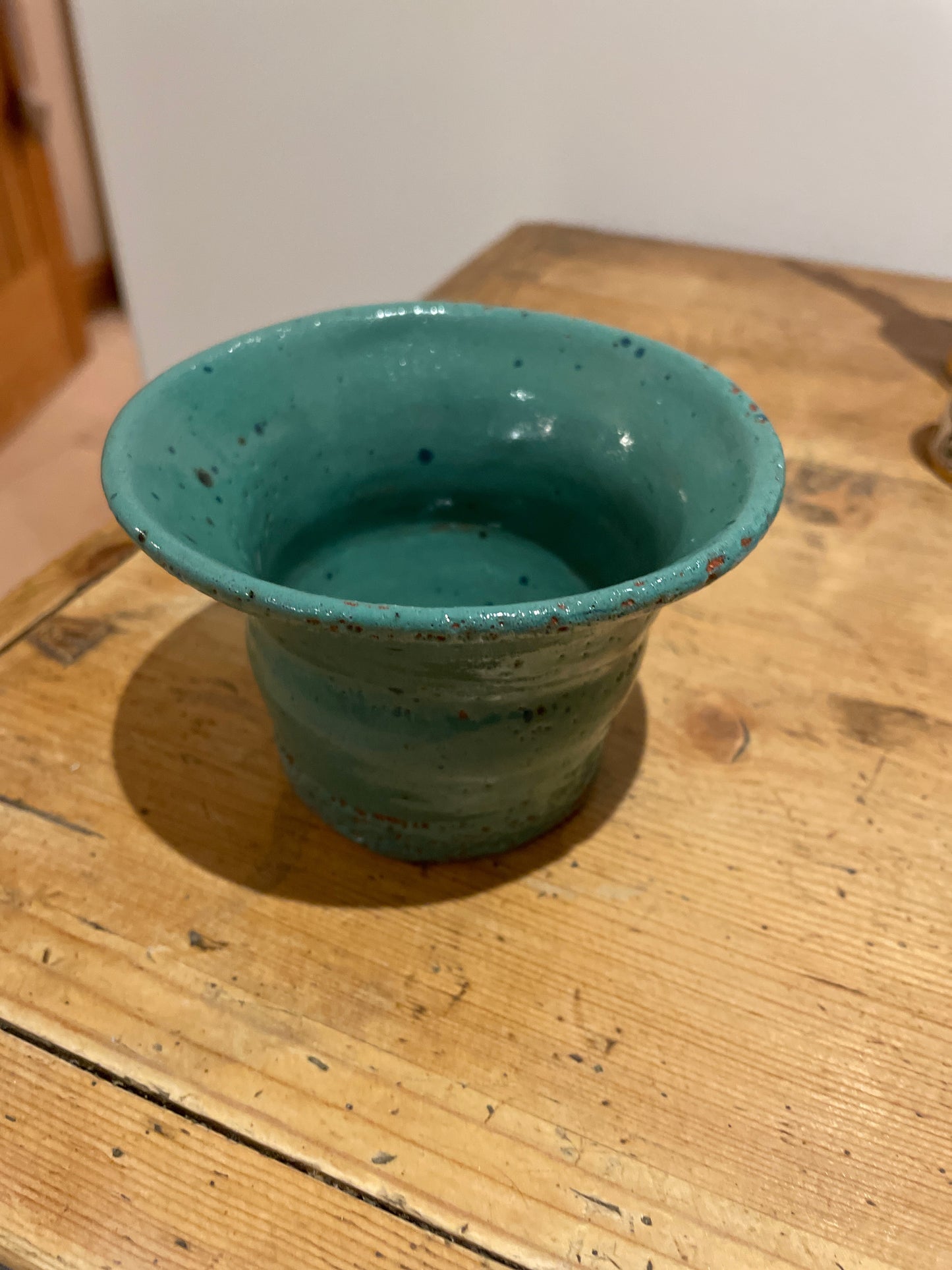 Green speckled hand thrown fluted vase