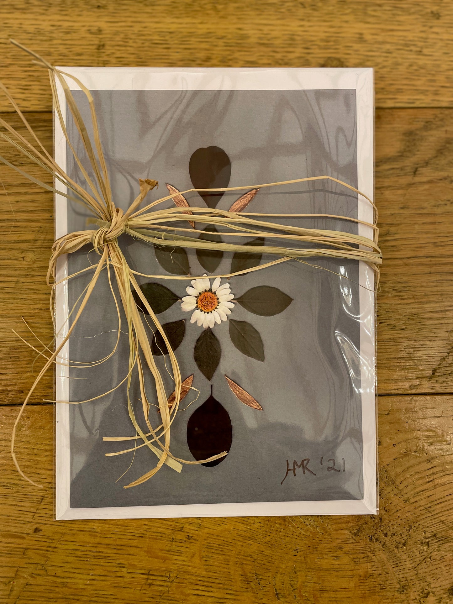 Daisy and green leaf greeting card