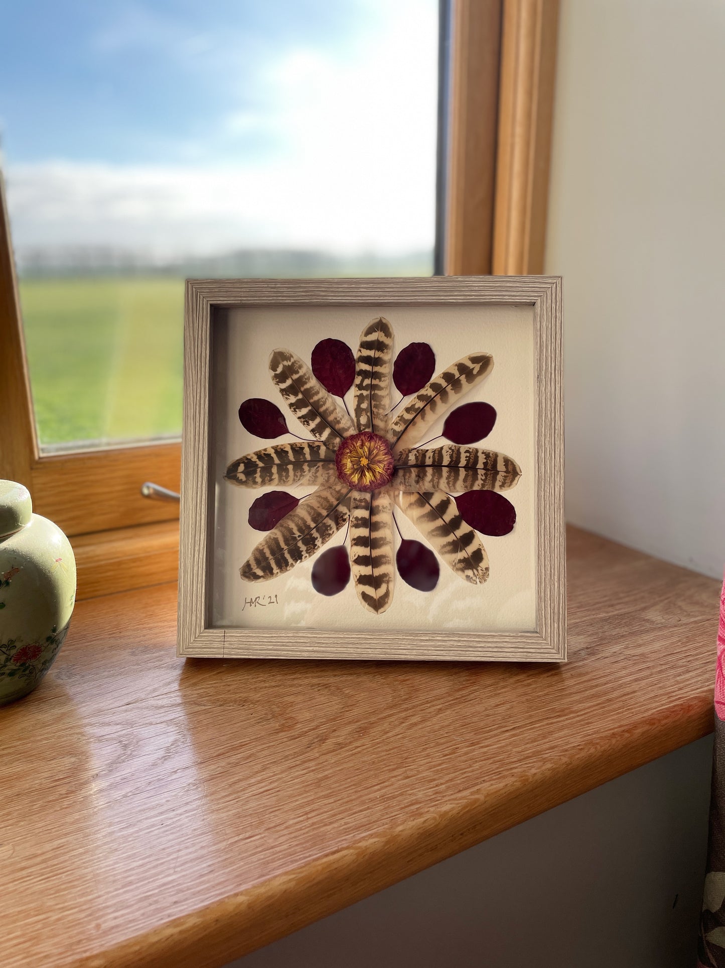 Box frame with pheasant feathers and red leaves