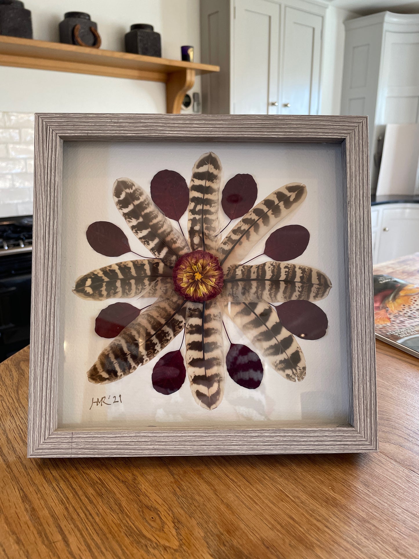 Box frame with pheasant feathers and red leaves