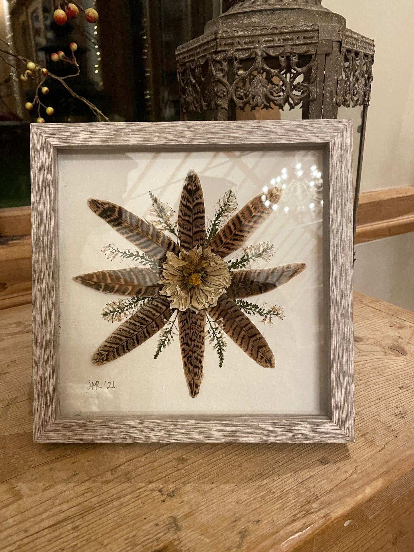 Box frame with pheasant feathers and a dahlia