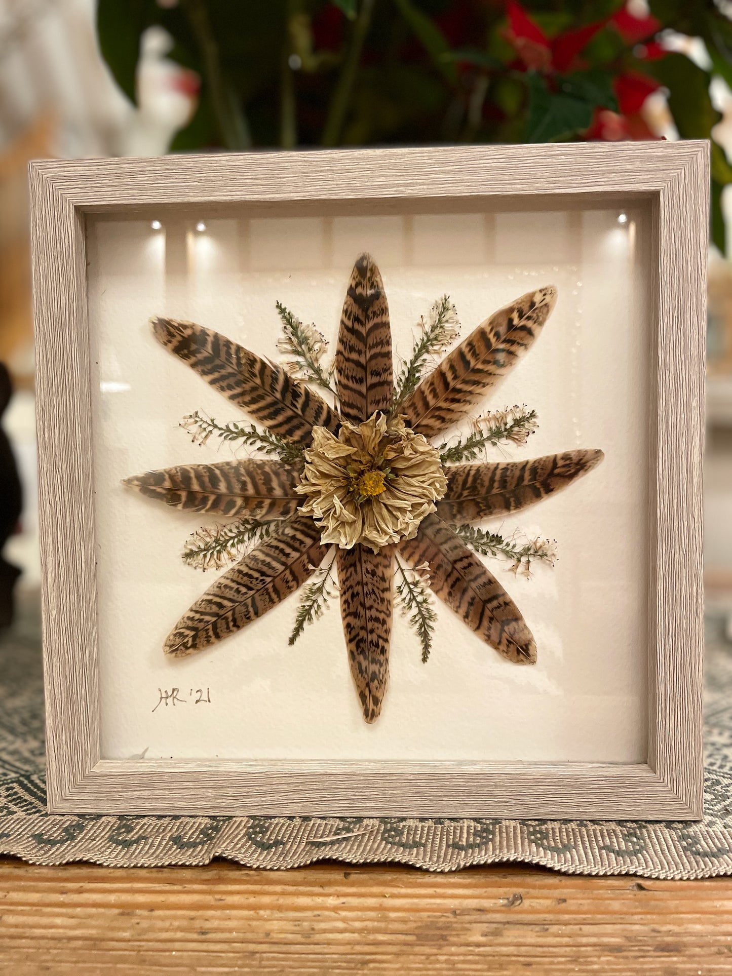 Box frame with pheasant feathers and a dahlia
