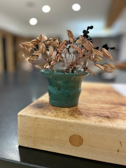 Green speckled hand thrown fluted vase