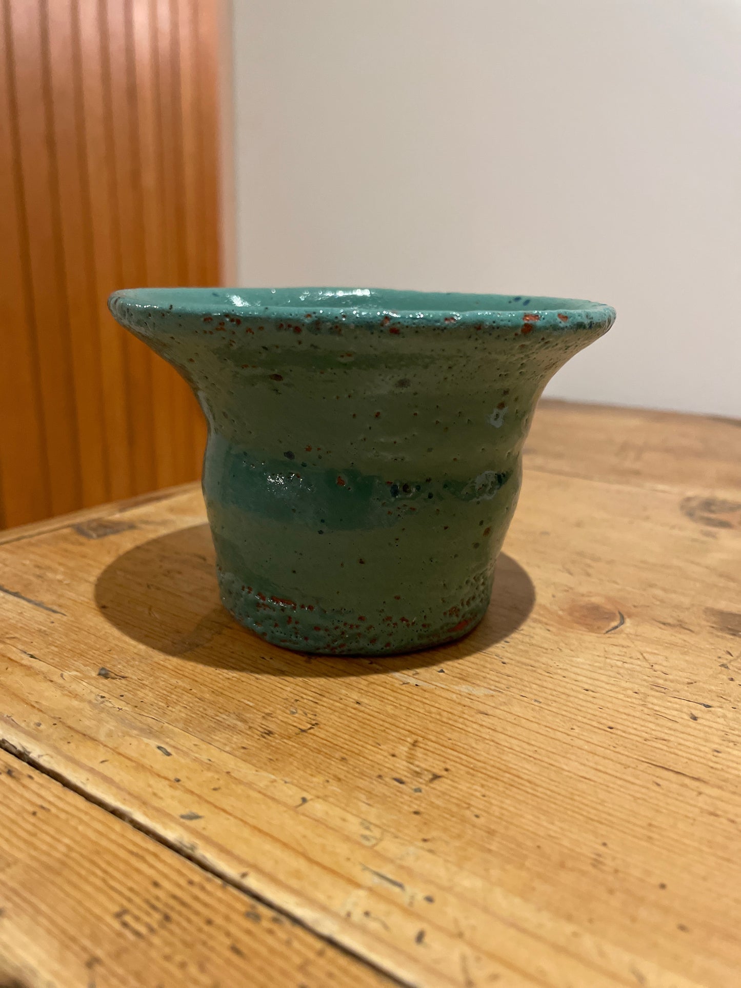 Green speckled hand thrown fluted vase